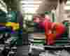 A woman in red sportswear lifts dumbells at the gym