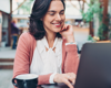 woman sat working at a coffee shop