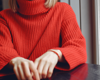 close up of woman wearing red knitted jumper