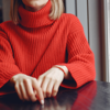 close up of woman wearing red knitted jumper