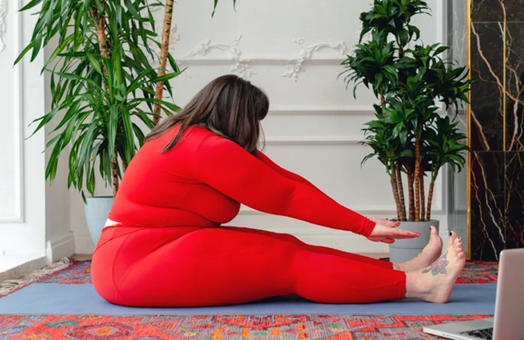 woman in red set stretching