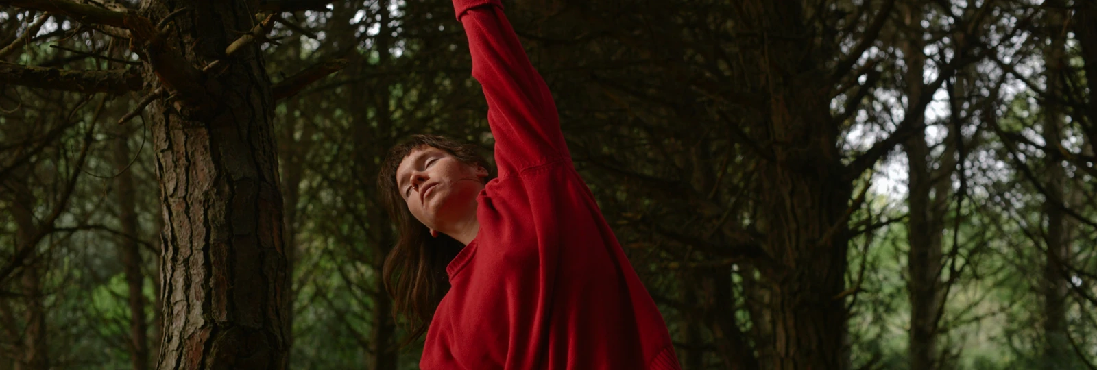 woman in red jumper streching