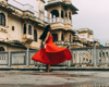 woman dancing in the street in red dress