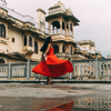 woman dancing in the street in red dress