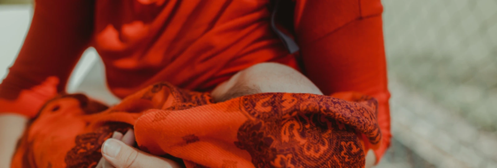 baby wrapped in red capulana