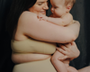 mother holding and smiling at baby