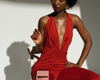 woman in red jumpsuit with pink calculator