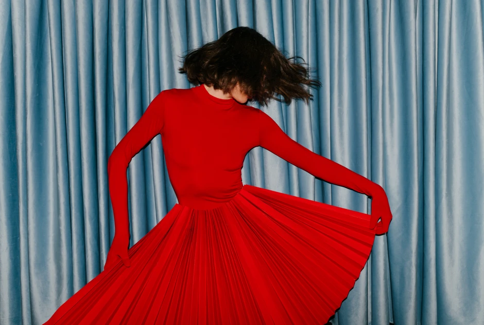 woman dancing in a red dress.