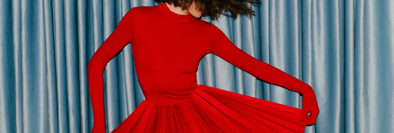woman dancing in a red dress.