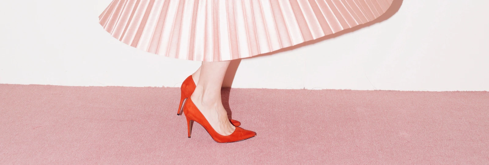 woman dancing in a pink skirt ona pink carpet
