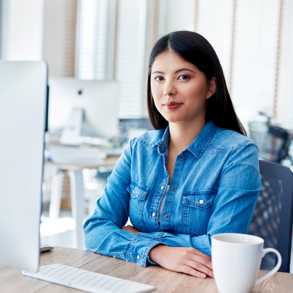 woman sat at the computer looking at the camera