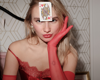 Woman wearing red gloves and dress with red queen card on her forehaed