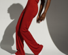 woman in red jumpsuit posing on white backdrop