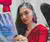 woman in red reading looking at camera