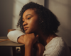 young woman at the desk, looking out the window